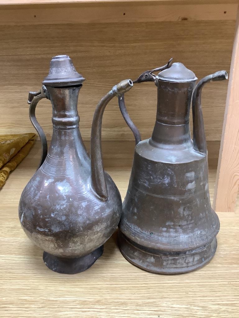 Seven Arabic tinned copper coffee pots, tallest being 34cm high